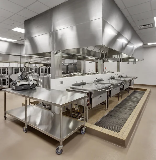a commercial kitchen with several prep stations and food prep equipment